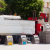 Recycling truck picking up bin at city street. Spain